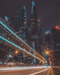 Illuminated cityscape against sky at night