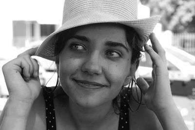 Portrait of smiling woman holding hat