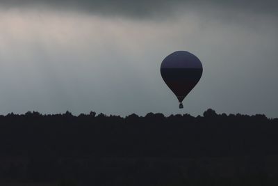 Silhouette of hot air balloon against sky