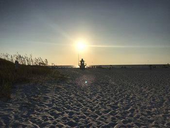 Scenic view of beach against sky during sunset