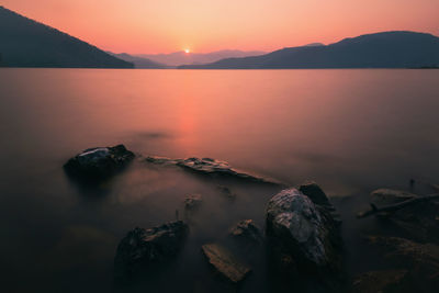 Scenic view of lake against sky during sunset