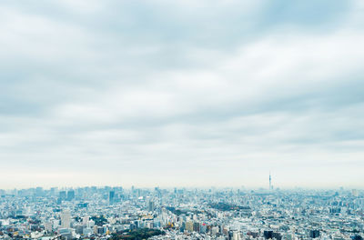 High angle view of city against cloudy sky