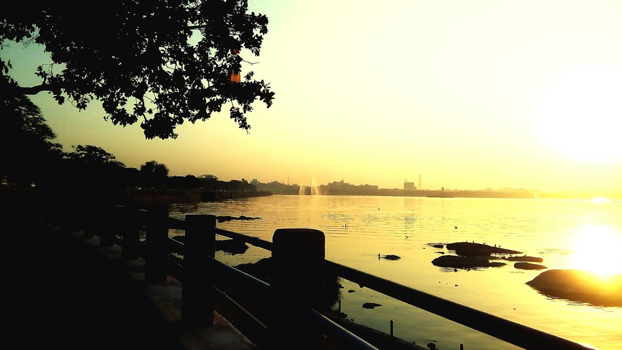 sunset, sun, water, transportation, silhouette, orange color, mode of transport, scenics, tranquility, tranquil scene, nautical vessel, beauty in nature, reflection, sunlight, nature, sky, lake, boat, river, clear sky