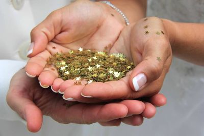 Close-up of hands holding star decorations