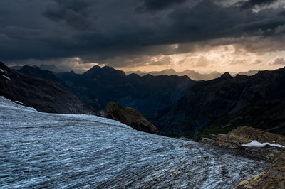 Scenic view of snowcapped mountains against sky during sunset