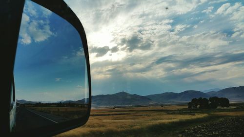 Scenic view of landscape against cloudy sky