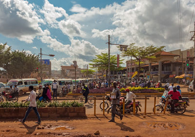 People on street in city against sky