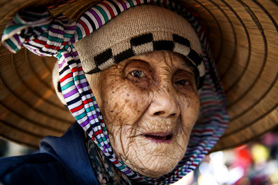 Close-up portrait of woman wearing hat