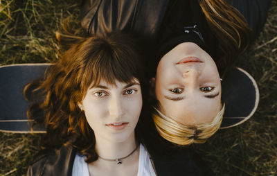 Directly above portrait of female friends lying down