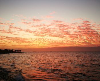 Scenic view of sea against romantic sky at sunset