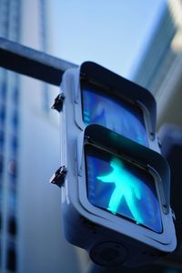 Low angle view of road signal against blue sky