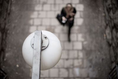 Close-up of woman on wall by street