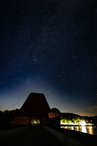 Low angle view of silhouette trees against sky at night