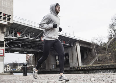 Full length of man jogging on street