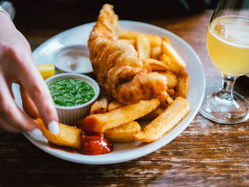 Close-up of hand holding soup served on table