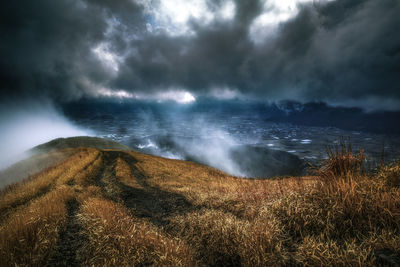 Scenic view of sea against storm clouds