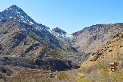 Scenic view of mountains against clear blue sky