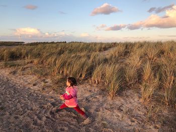 High angle view girl standing with legs apart on field