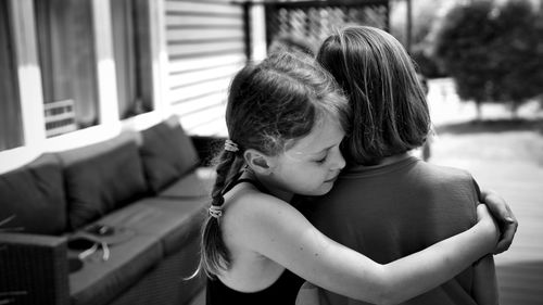 Rear view of mother and daughter outdoors