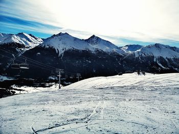 Scenic view of snowcapped mountains against sky