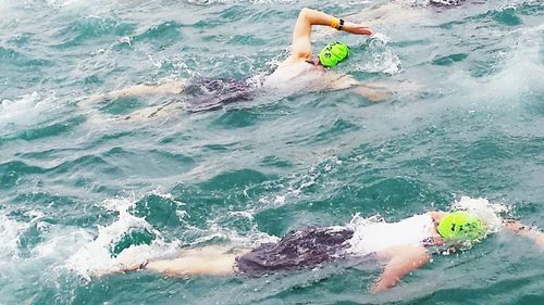 People surfing in sea