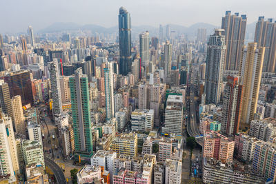 Aerial view of modern buildings in city against sky