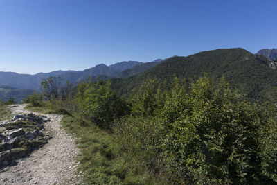 Scenic view of mountains against blue sky