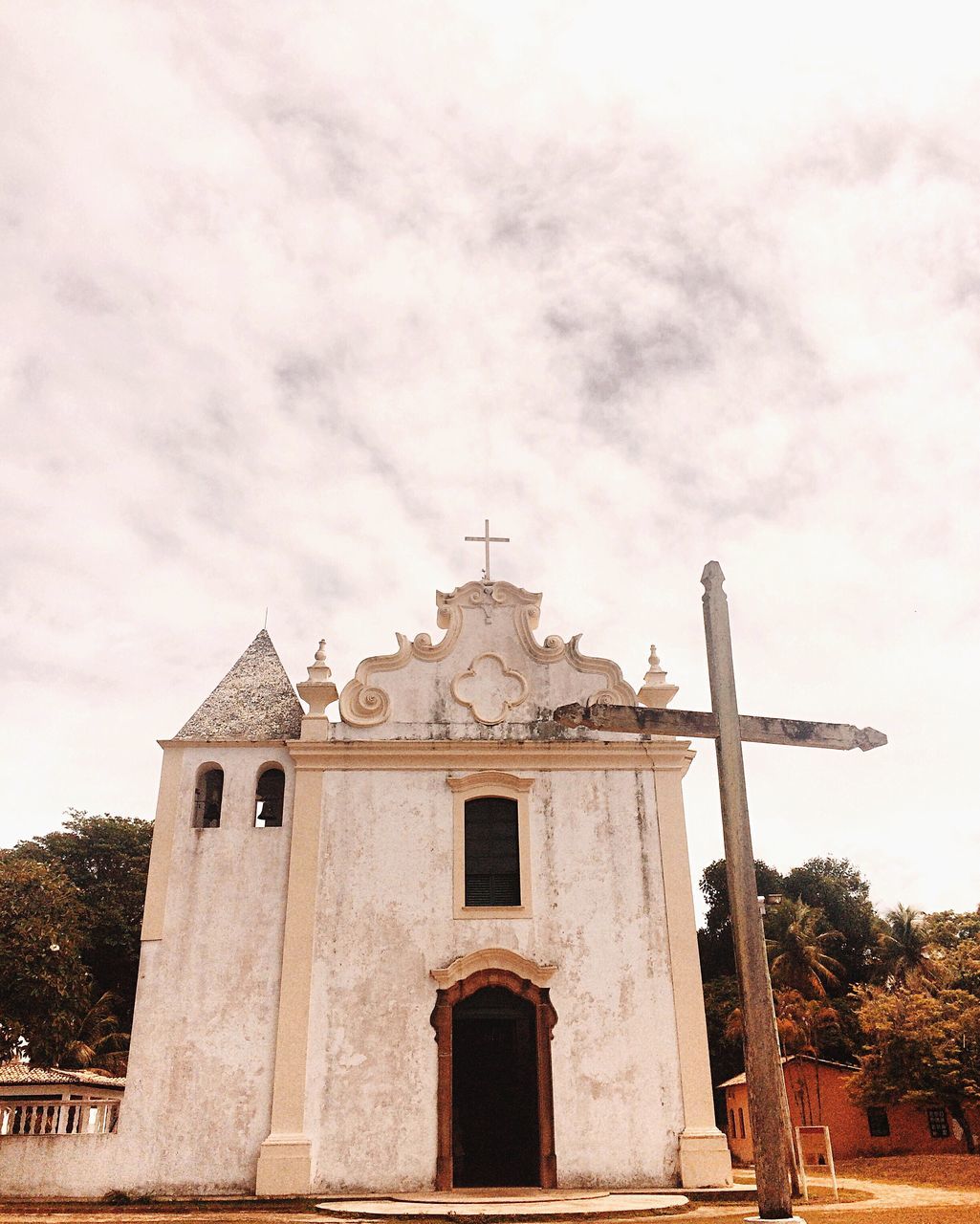 architecture, built structure, building exterior, low angle view, religion, sky, church, place of worship, spirituality, cross, cloud - sky, tree, old, day, cloudy, outdoors, cloud, no people