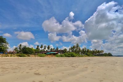 Scenic view of beach against blue sky