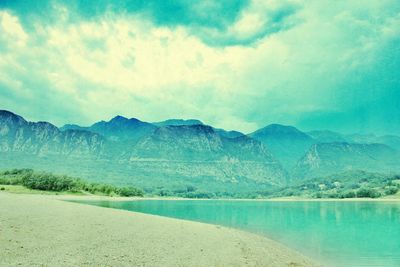 Scenic view of lake against cloudy sky