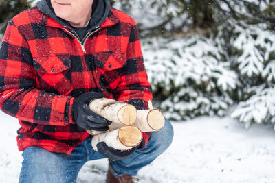 Midsection of boy holding ice cream standing during winter