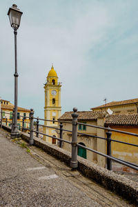 Street amidst buildings in city against sky