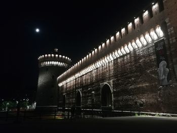 Low angle view of illuminated building against sky at night