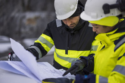 Construction engineers discussing project at construction site