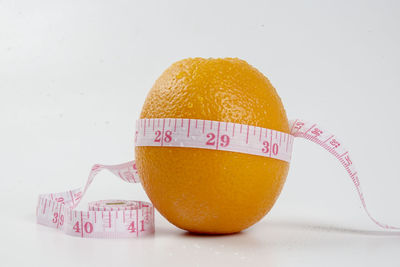 Close-up of orange slice over white background