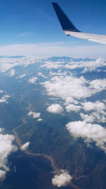 Cropped image of airplane flying over landscape
