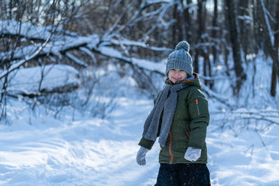 Rear view of woman standing in snow