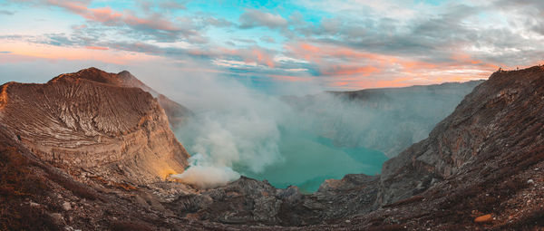 Smoke emitting from volcanic mountain against sky