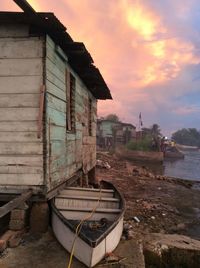 Abandoned boat by cottage