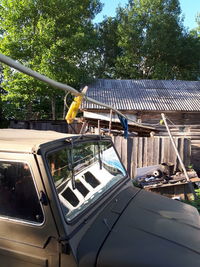 Built structure by trees against sky