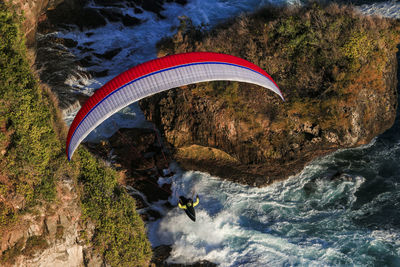 High angle view of man flying over mountain