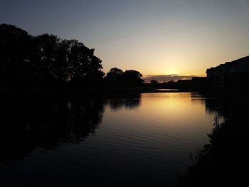 Scenic view of lake against sky during sunset