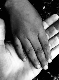 Close-up of mother holding hands