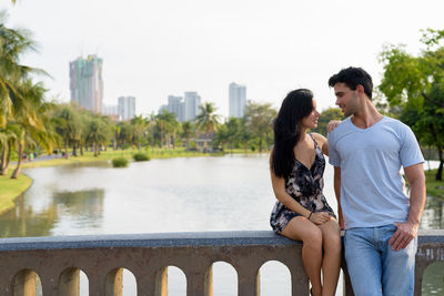 Young couple on bridge over water