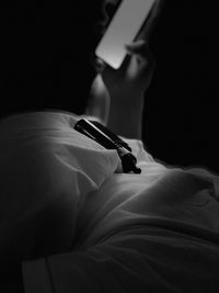 Close-up of woman reading book on bed