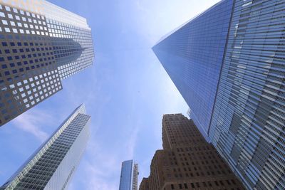 Low angle view of modern buildings against blue sky