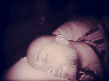 Close-up of man sleeping in bed