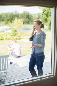 Couple using technologies on porch