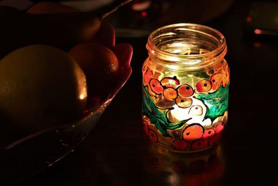 Close-up of illuminated jar on table