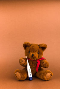 Close-up of stuffed toy against orange background